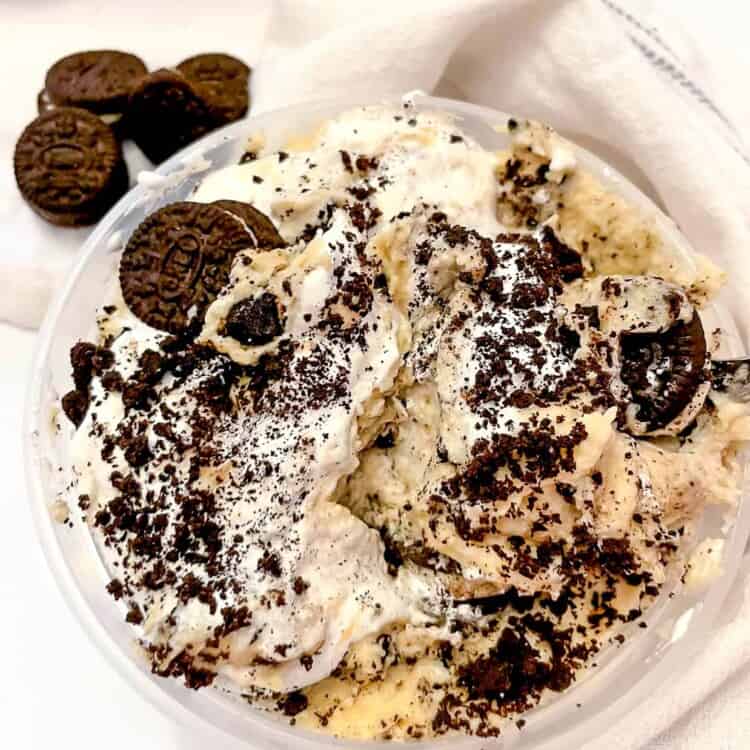 Protein cookie dough topped with addtional oreo cookie pieces in a bowl.