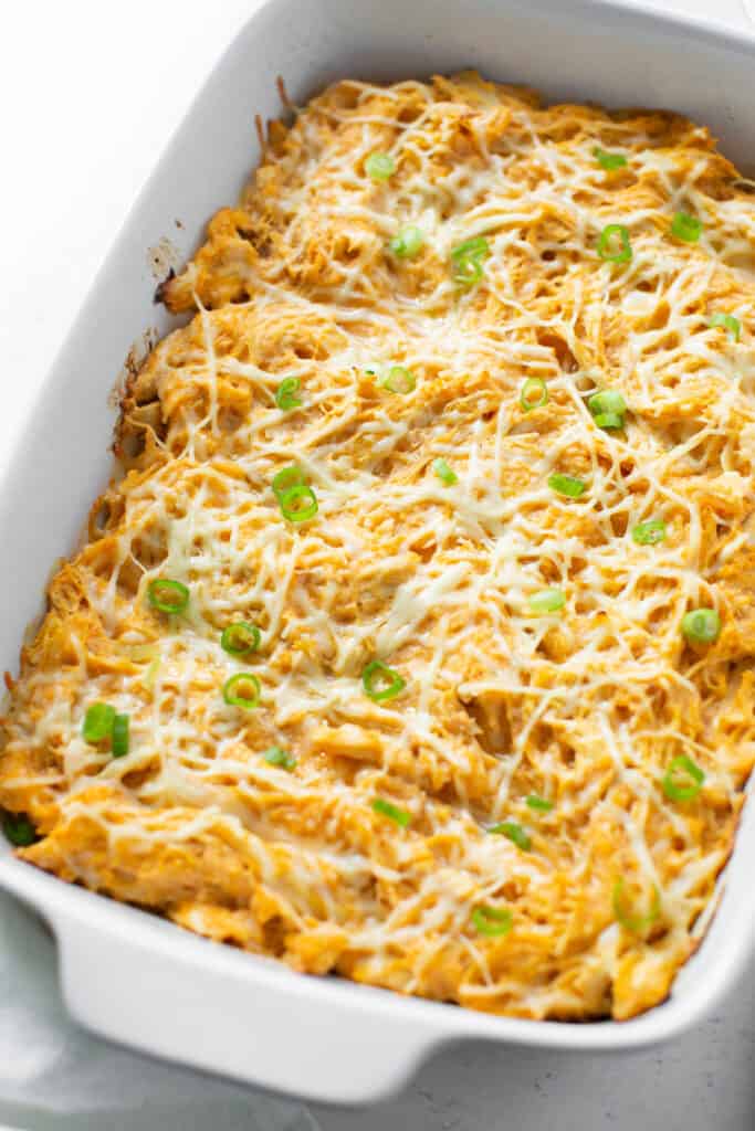 Macro Friendly Buffalo chicken, spaghetti squash, and cheese baked in a casserole dish topped with green onions