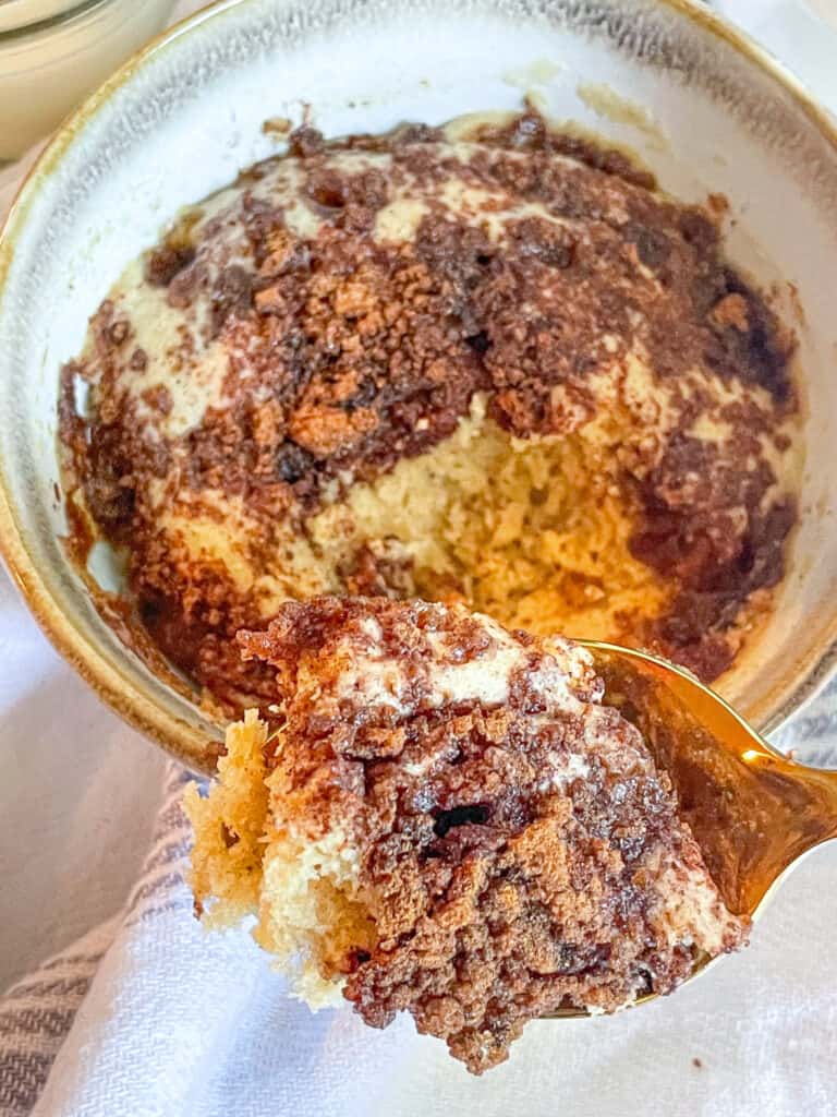 Zoomed in view of Healthy Coffee Cake in a Mug with a spoon.
