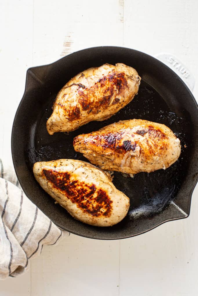 3 cooked chicken breasts in a skillet