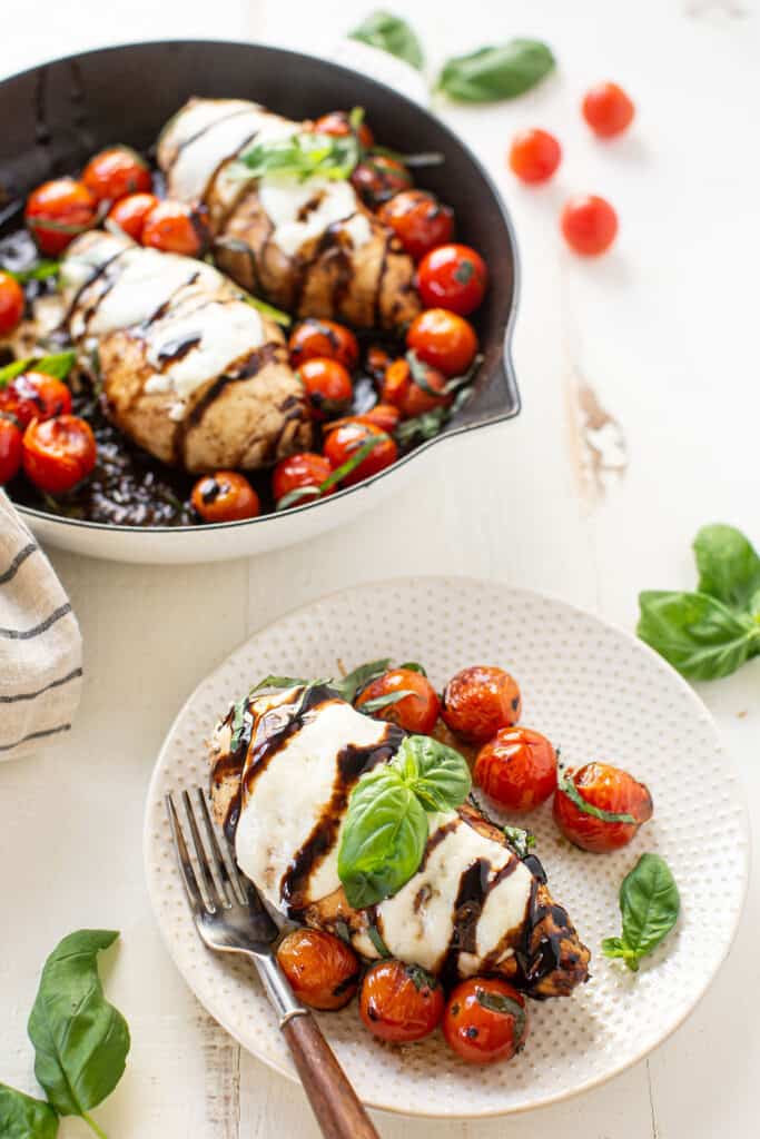 Caprese chicken on a white plate
