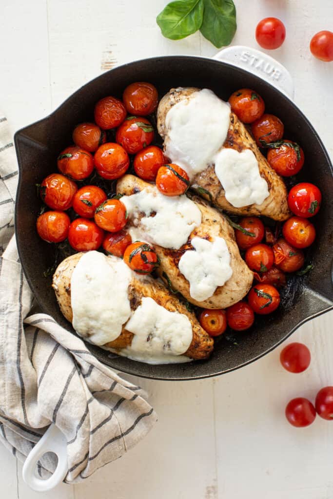 Chicken breasts topped with melted mozzarella cheese and tomatoes