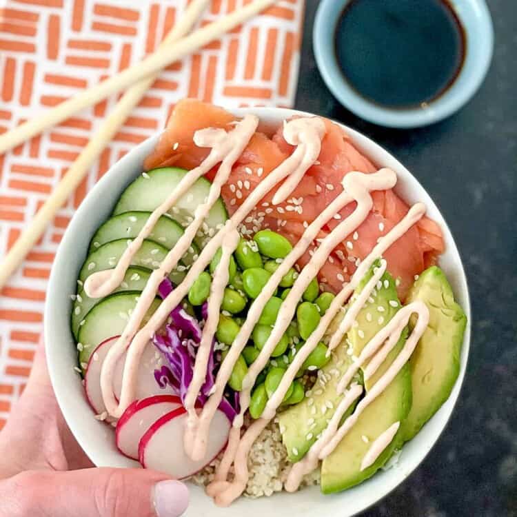 Low carb poke bowl with chopstick and a small bowl of soy sauce.