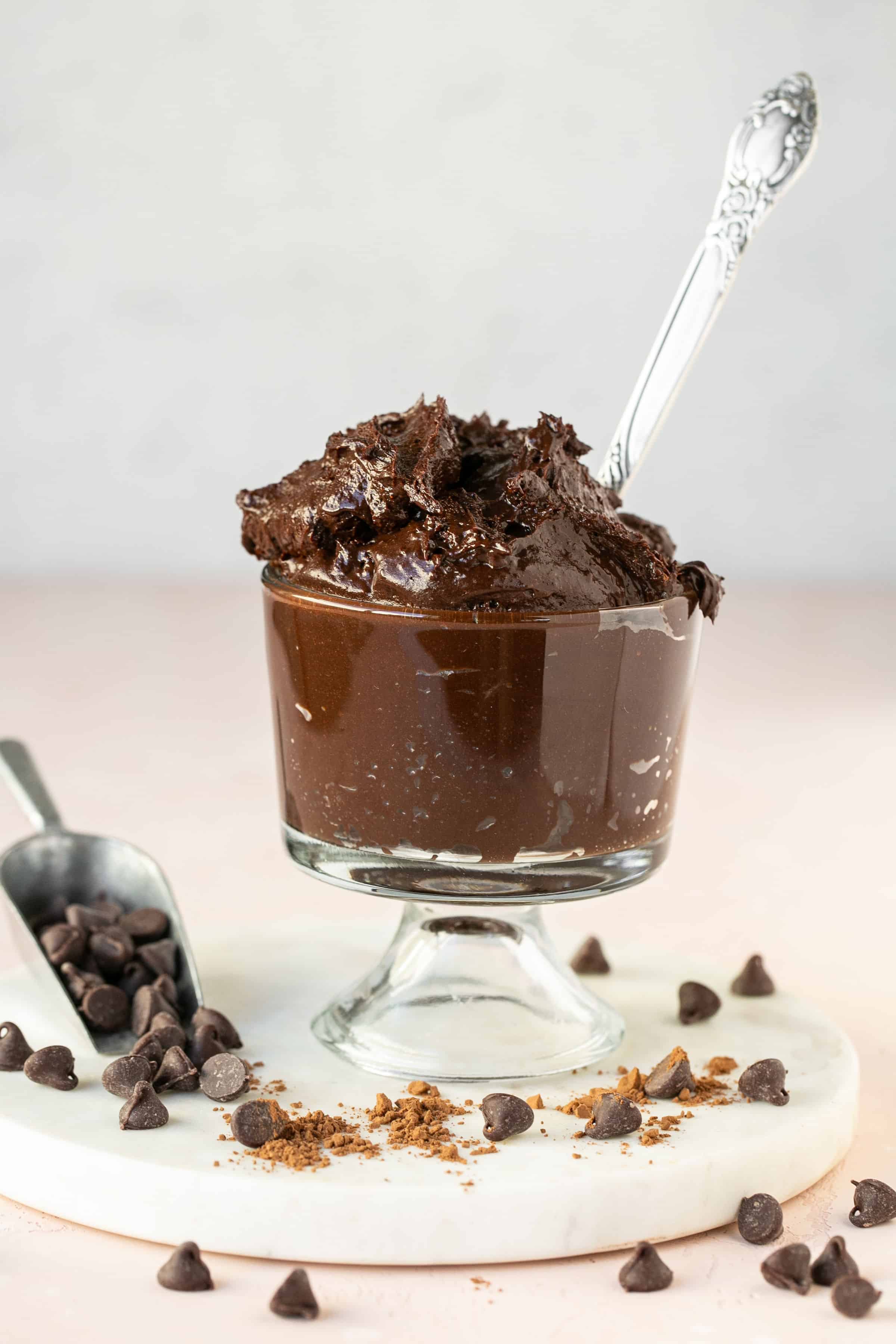 Healthy brownie batter in a small bowl with a spoon.