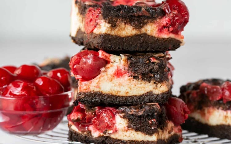 Cherry Cheesecake Brownies, some stacked on top of each other.