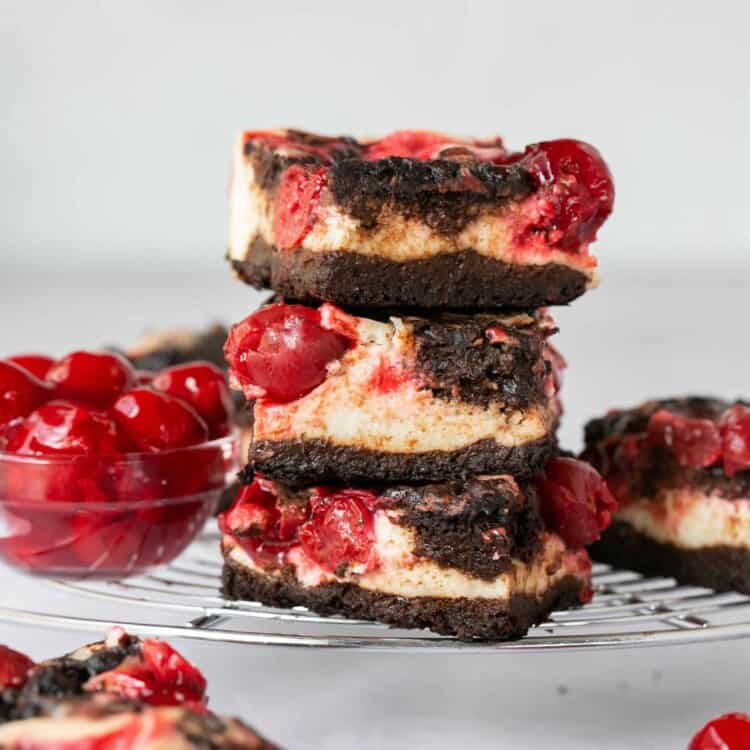Cherry Cheesecake Brownies, some stacked on top of each other.