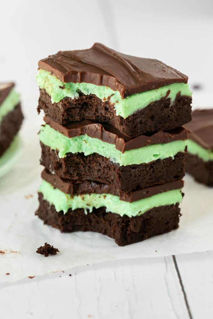 Chocolate mint brownies stacked on top of each other.