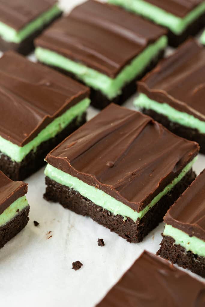 Chocolate mint brownies on parchment paper.