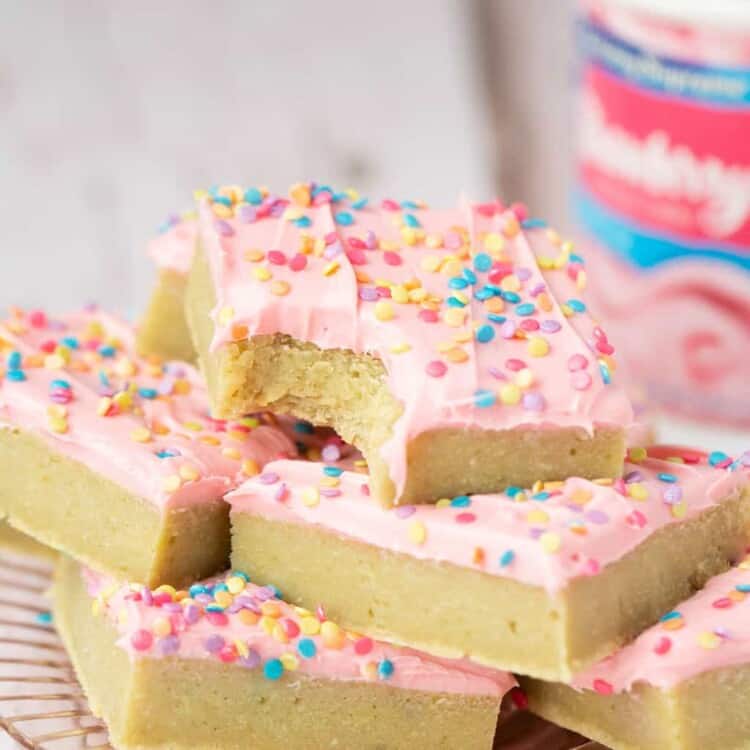 Sugar cookie bars stacked on a plate.