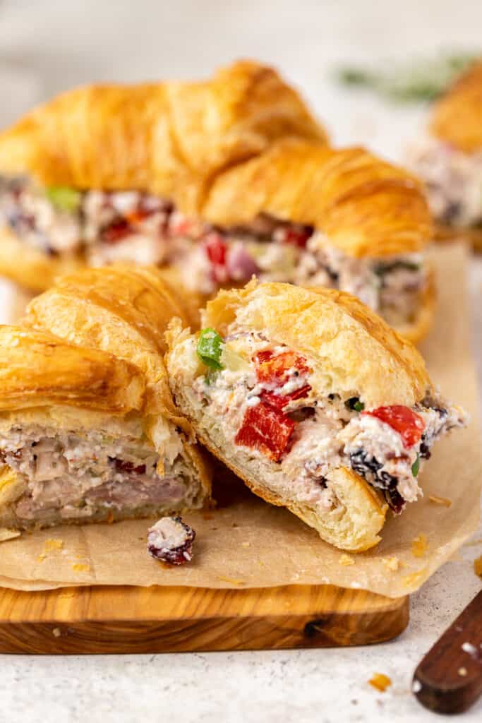 Winter Pecan and Cranberry Chicken Salad on a croissant cut in half.