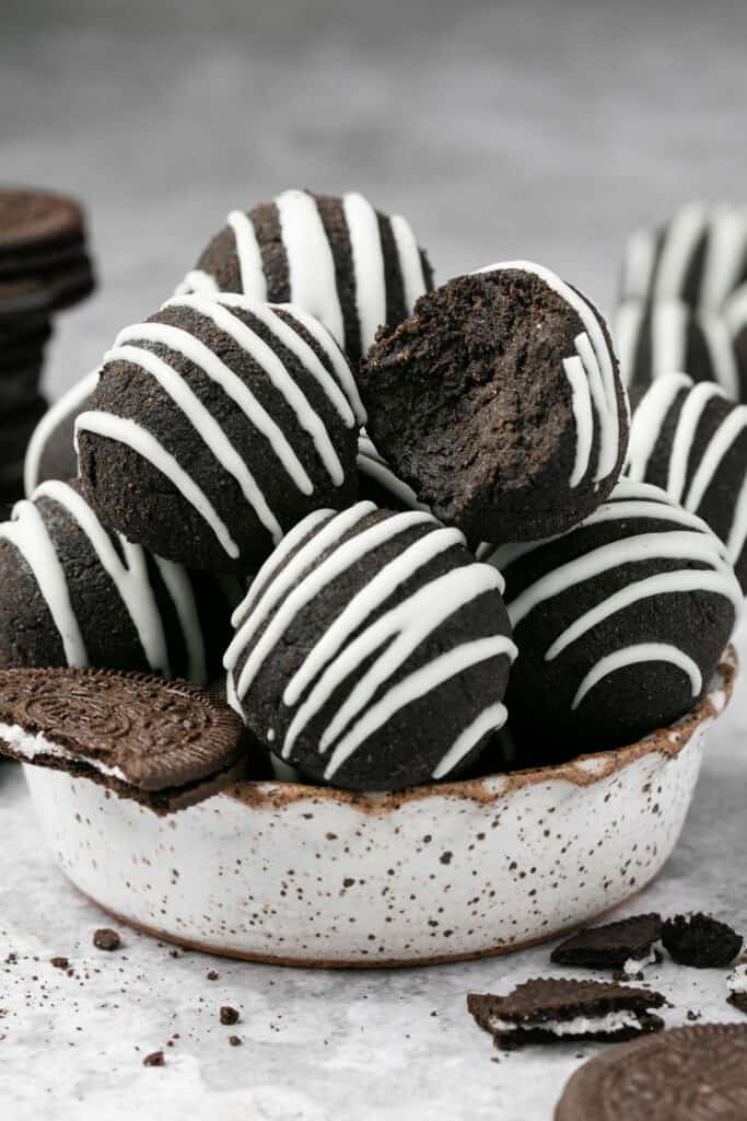 Zoomed in view of white chocolate oreo protein balls in a bowl.