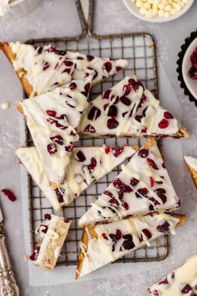 Cranberry bliss bars on a cooling rack.