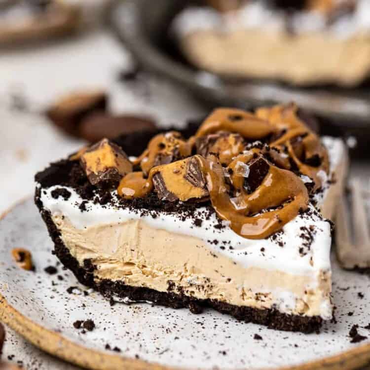 No bake oreo peanut butter pie topped with chopped Reese's on a small plate.