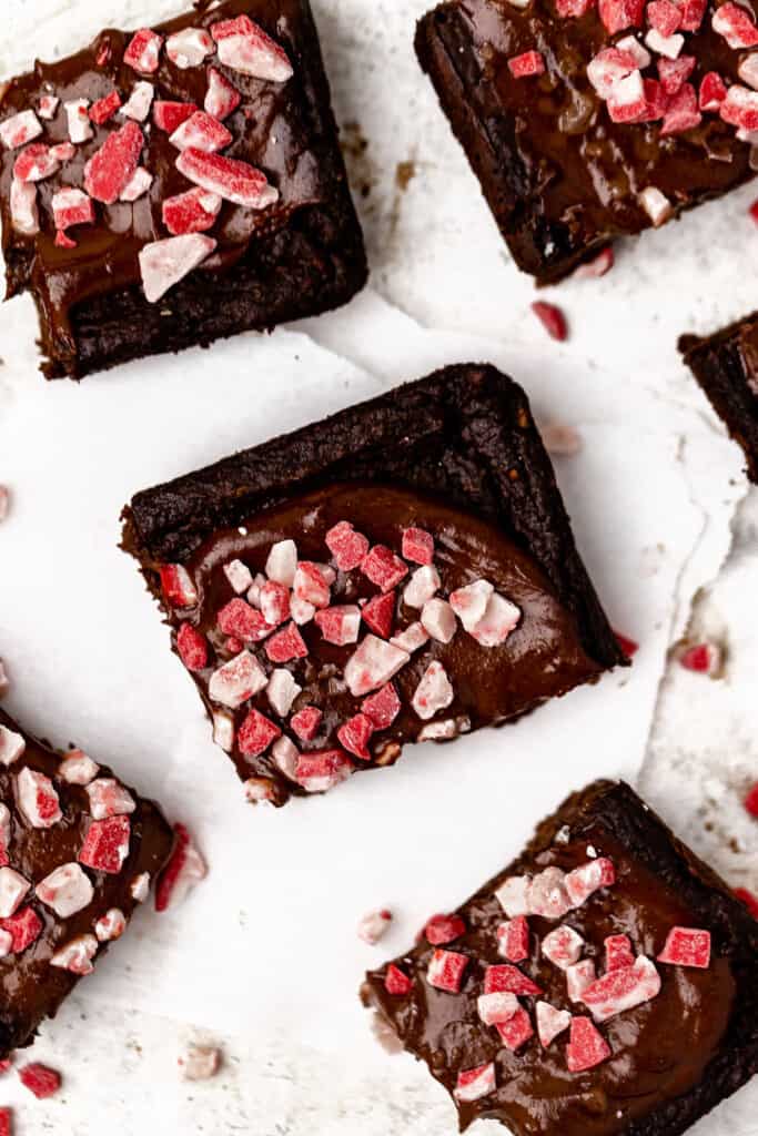 Zoomed in view of Peppermint brownies cut into bars on parchment paper.