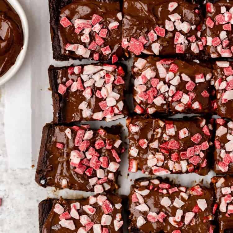 Peppermint brownies cut into bars on parchment paper.