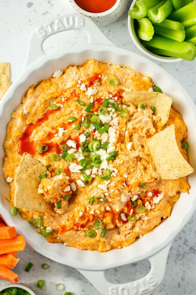 Macro Friendly Healthy Buffalo Chicken Dip Recipe served in a dish with chips and celery