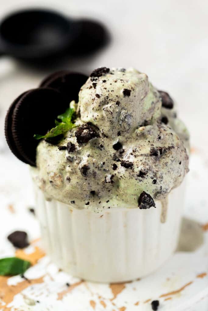 Mint protein ice cream in a small bowl topped with Oreos.