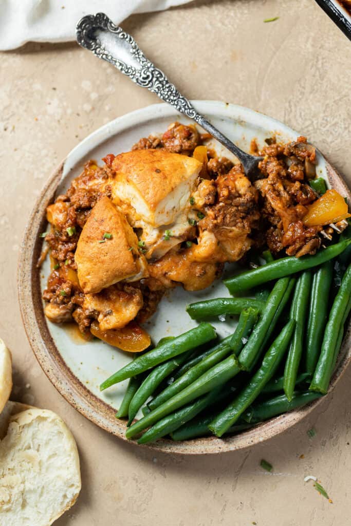 Sloppy joe biscuit bake recipe on a plate with green beans