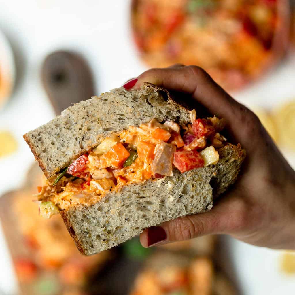 Inside shot of buffalo chicken salad sandwich being held in my hand. 