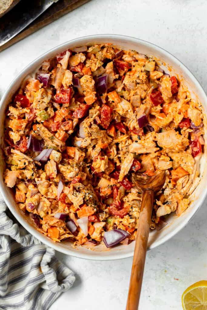 Ingredients mixed together for creamy buffalo chicken salad.