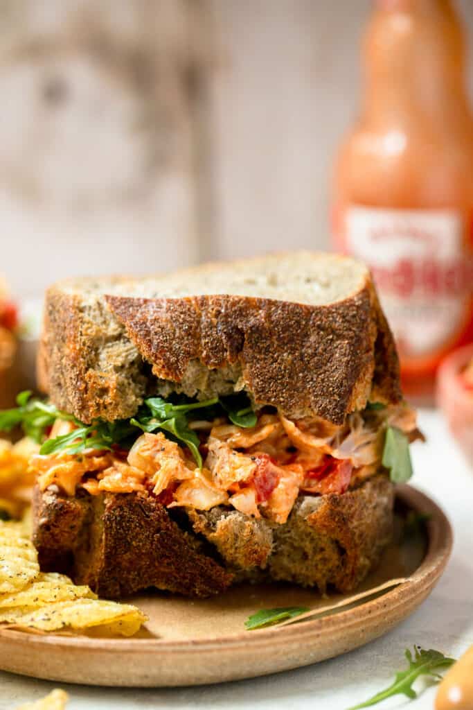 Buffalo chicken salad sandwich with frank's red hot and chips.