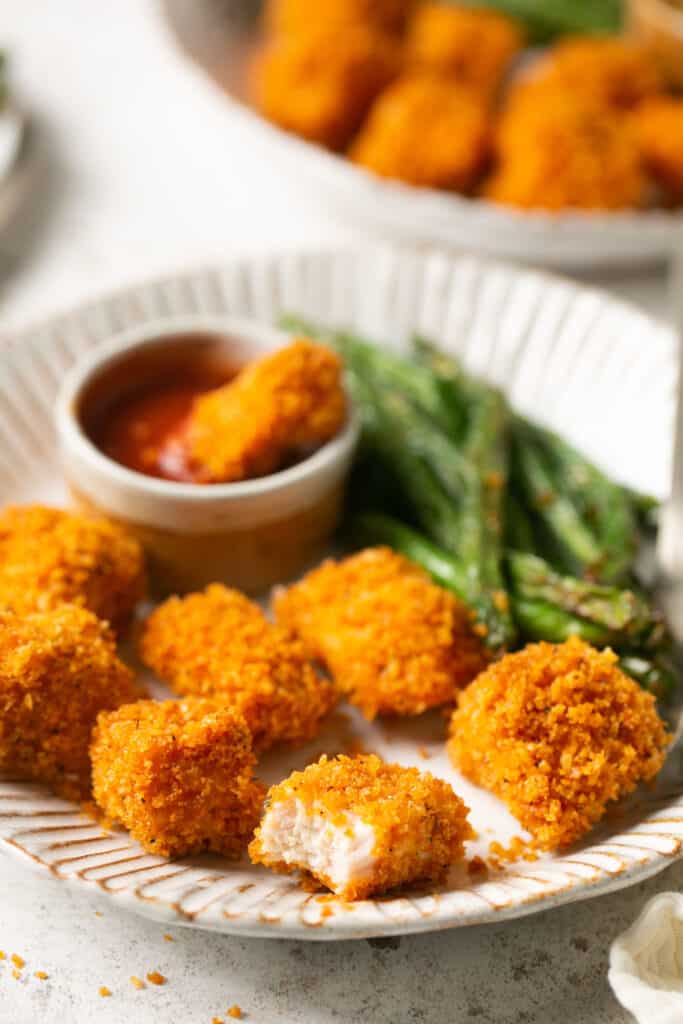 Panko baked chicken nuggets served on a plate with green beans