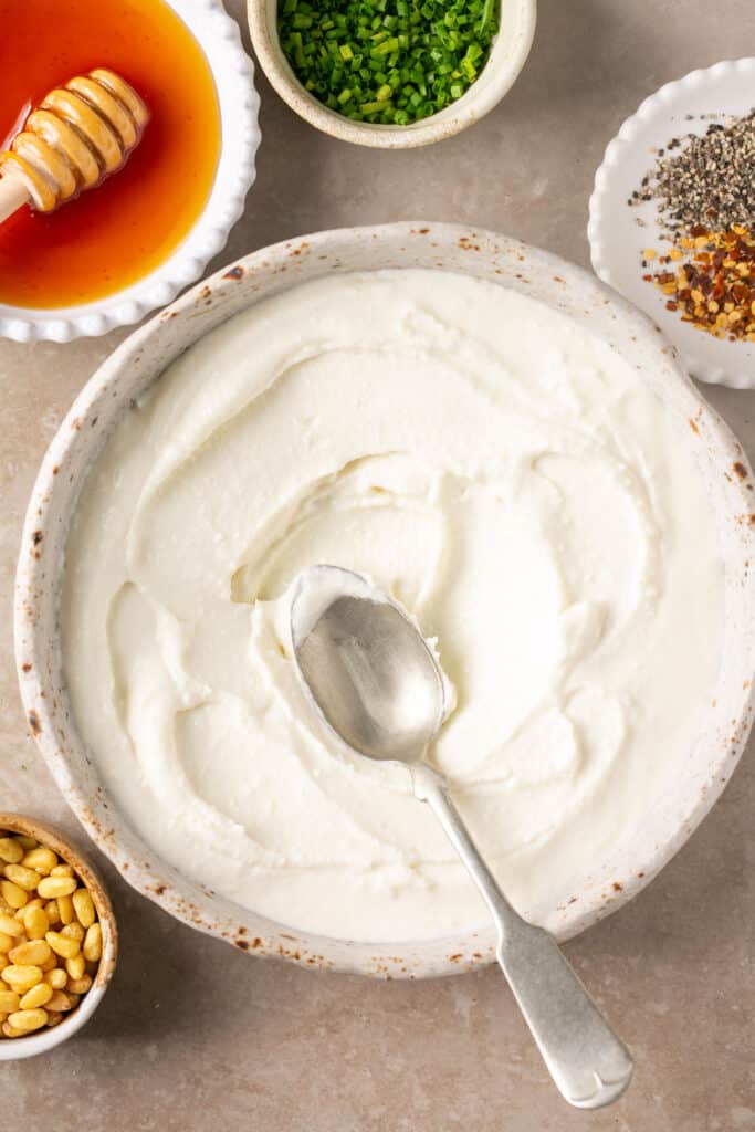 Whipped feta in a bowl with a spoon.
