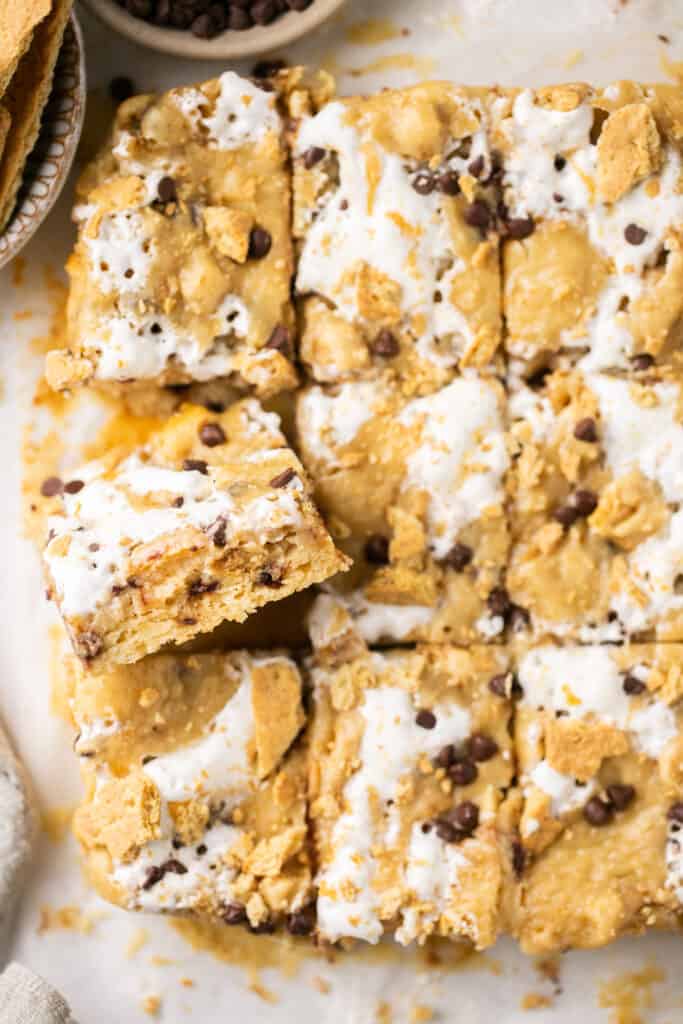 S'mores blondie bars with gooey marshmallow on parchment paper.