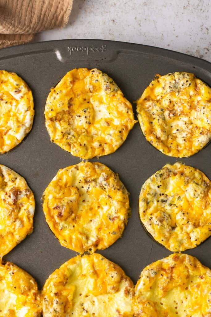 Bacon and cheese egg bites in a muffin pan.