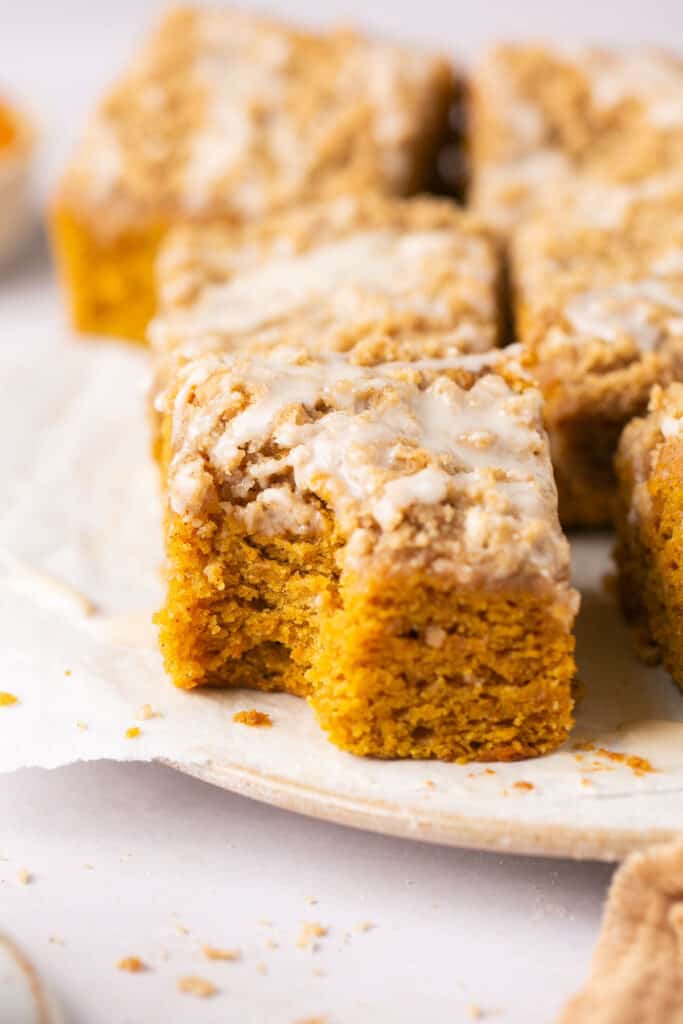 moist pumpkin coffee cake with brown sugar crumb topping square with a bite taken out of it