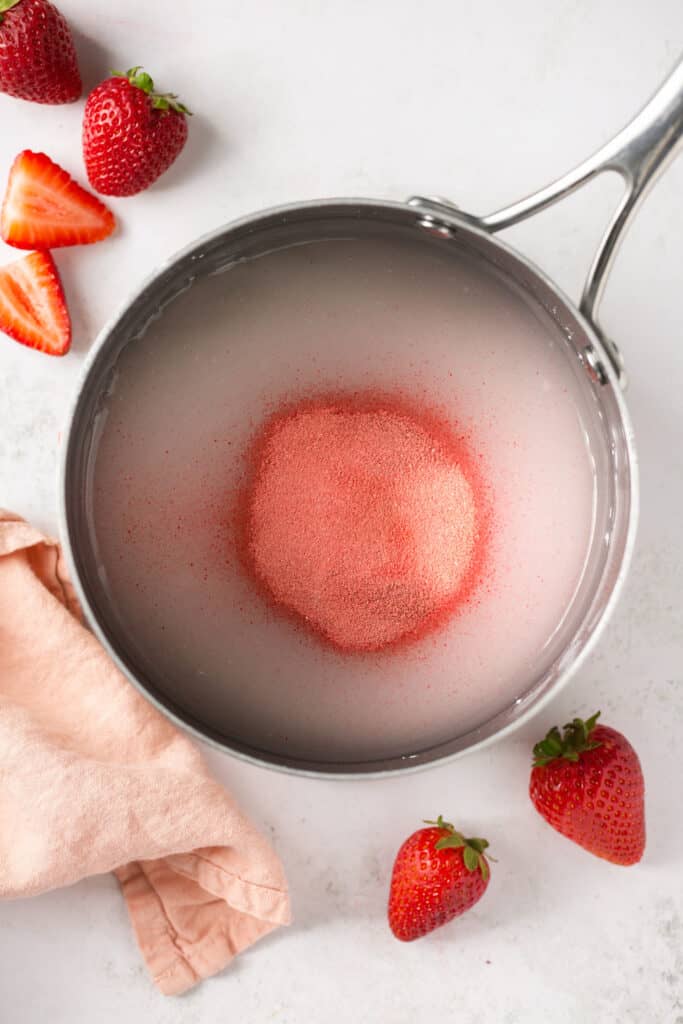 Ingredients for strawberry mixture in a saucepan.