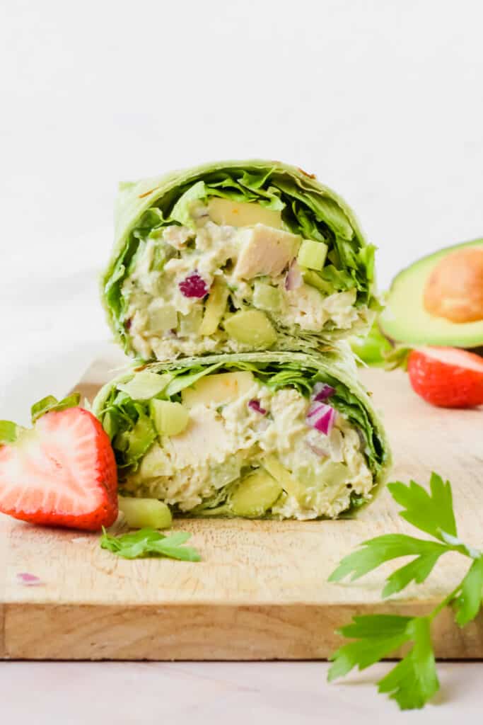 Avocado greek yogurt chicken salad with greens in a wrap.