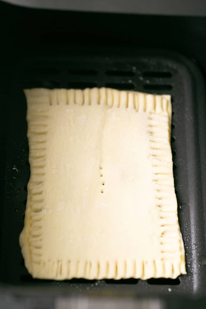 Air fryer pop tart in an air fryer basket.