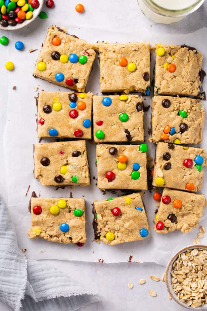 Monster Protein Cookie Dough Bars on parchment paper cut into squares