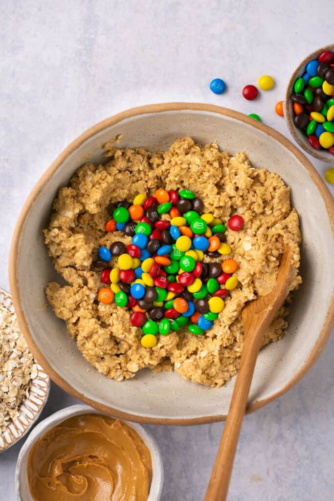 M&Ms addded to the cookie dough before being mixed together.