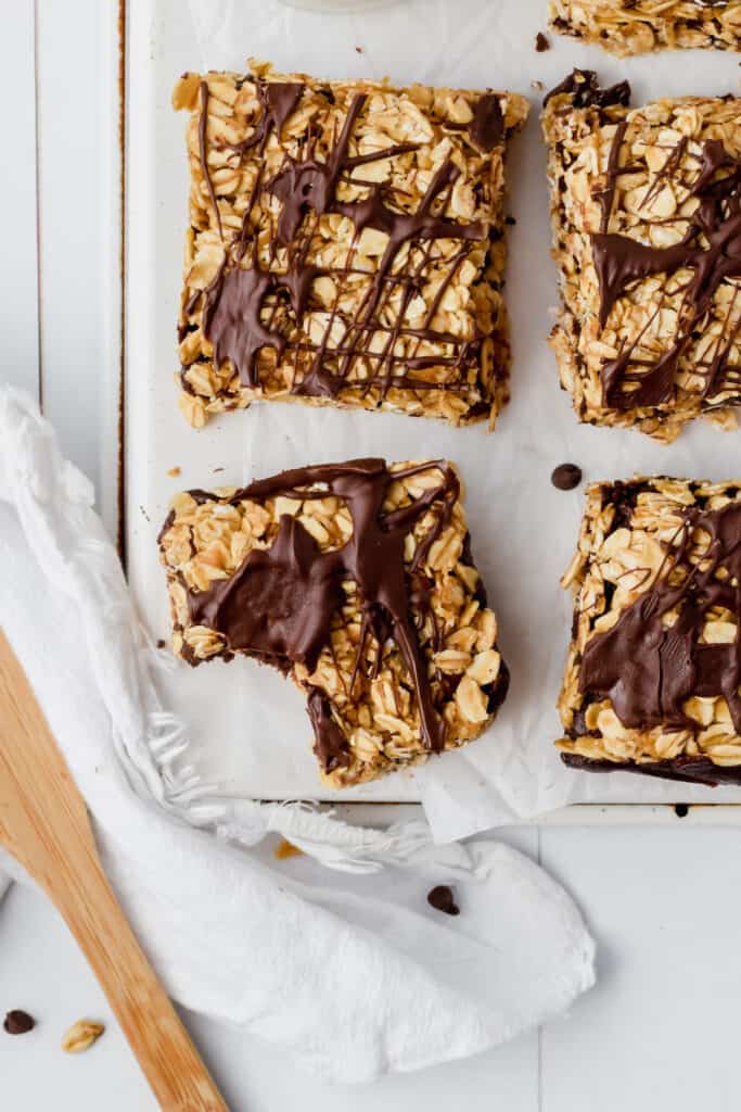 Healthy peanut butter oatmeal bars drizzled with chocolate amd cut into squares.