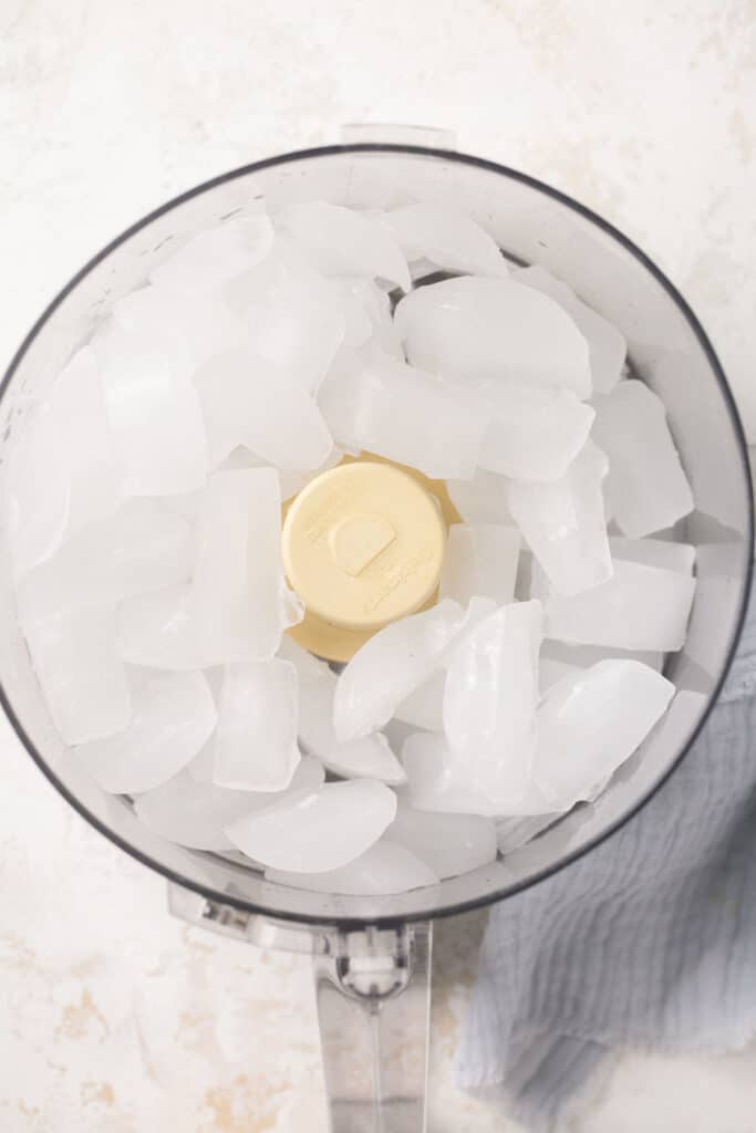 Ice cubes in a food processor before being crushed.