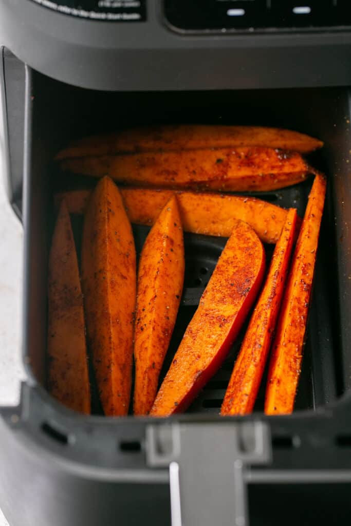 air fryer sweet potatoes in the air fryer right before being cooked. 