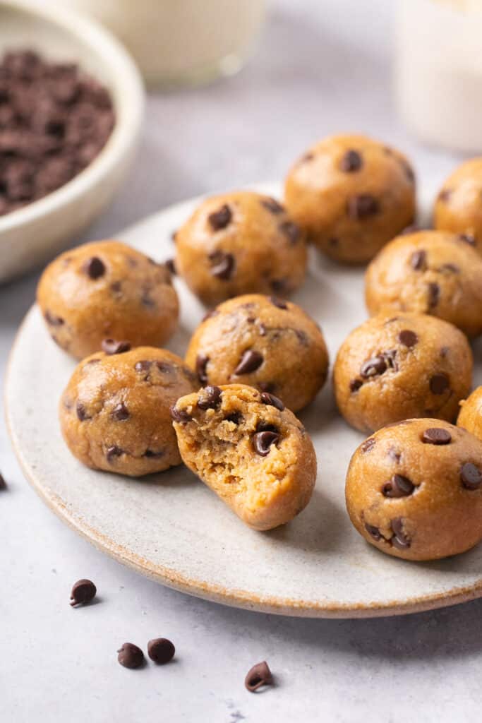 Zoomed in view of cookie dough protein bites on a plate.
