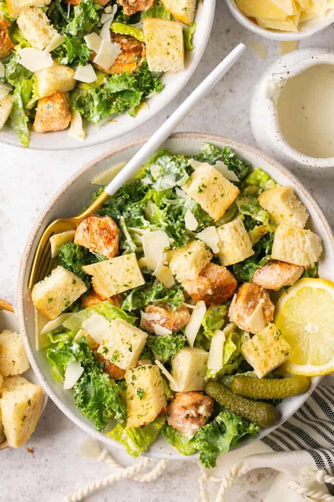 grilled chicken nugget caesar salad in a large bowl 