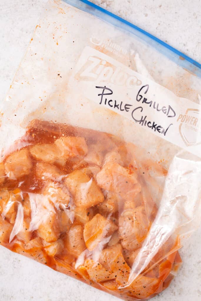 chicken marinating in a pickle brine in a ziploc bag 