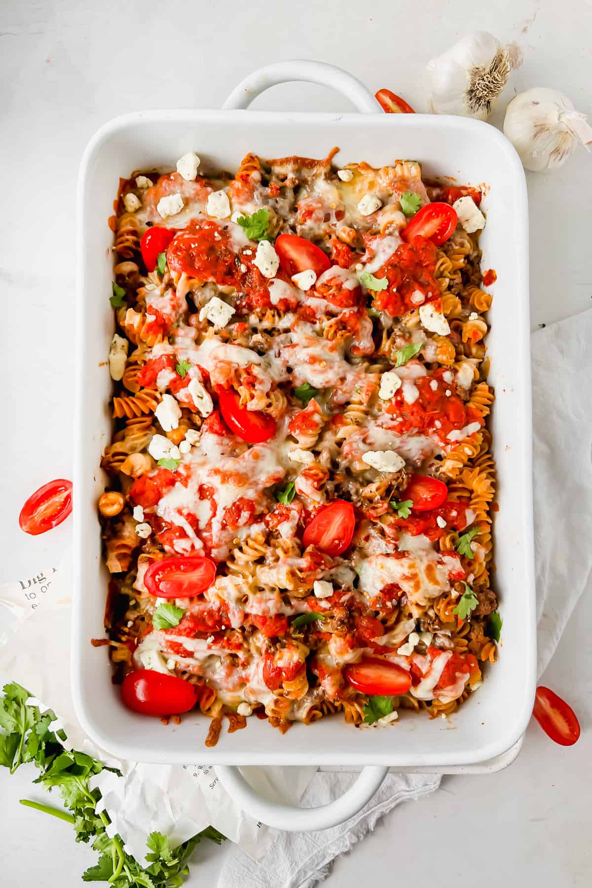 Rotini pasta bake in a baking dish after being baked.