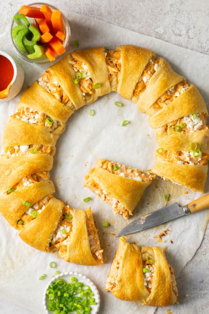 buffalo chicken crescent ring being sliced into pieces 