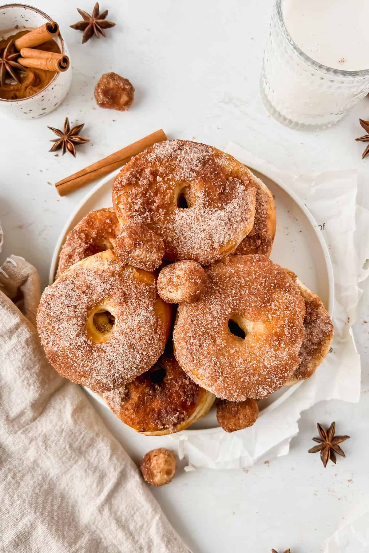 Cinnamon Sugar Air Fryer Donuts (with biscuits) in a bowl garnished with cinnamon sticks.