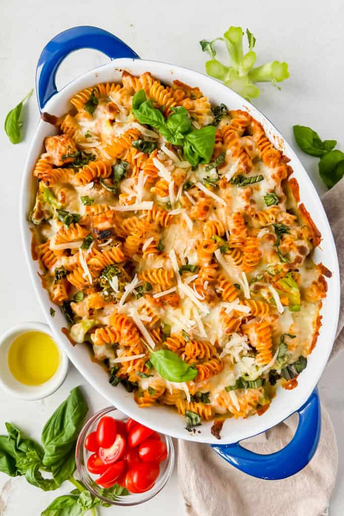 Italian Chicken and Broccoli Pasta Bake in a casserole dish topped with melty cheese after being baked.