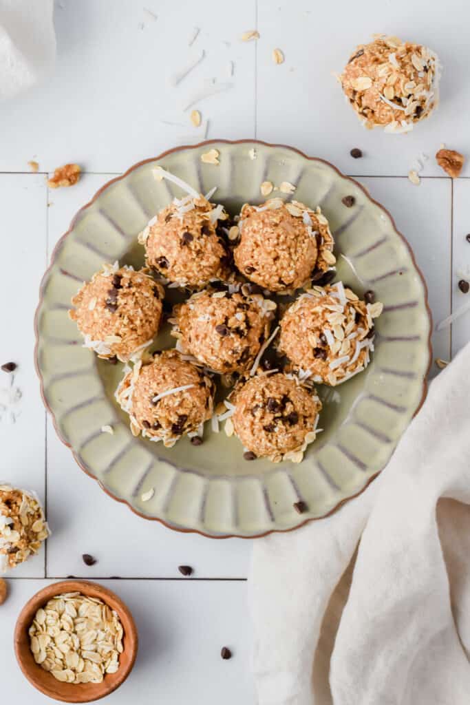 Oatmeal cashew cookie coconut protein balls on a serving plate.
