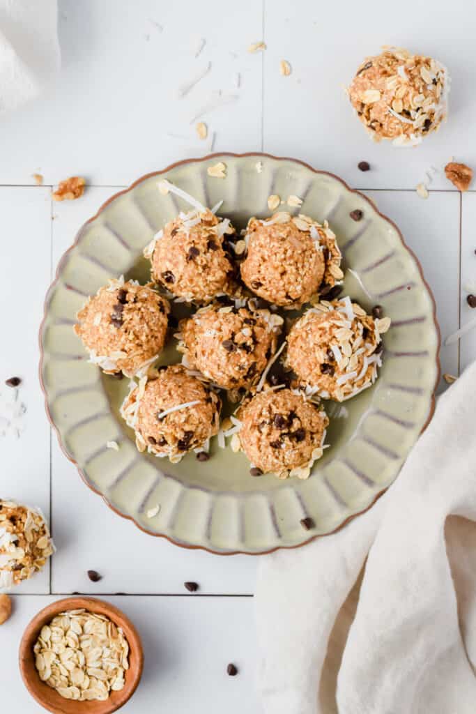 Oatmeal cashew cookie coconut protein balls on a plate.