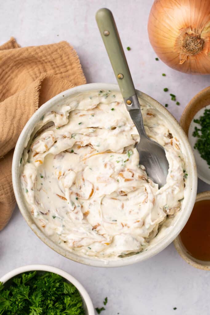 Cream cheese and mayo mixed with the onions in a bowl.