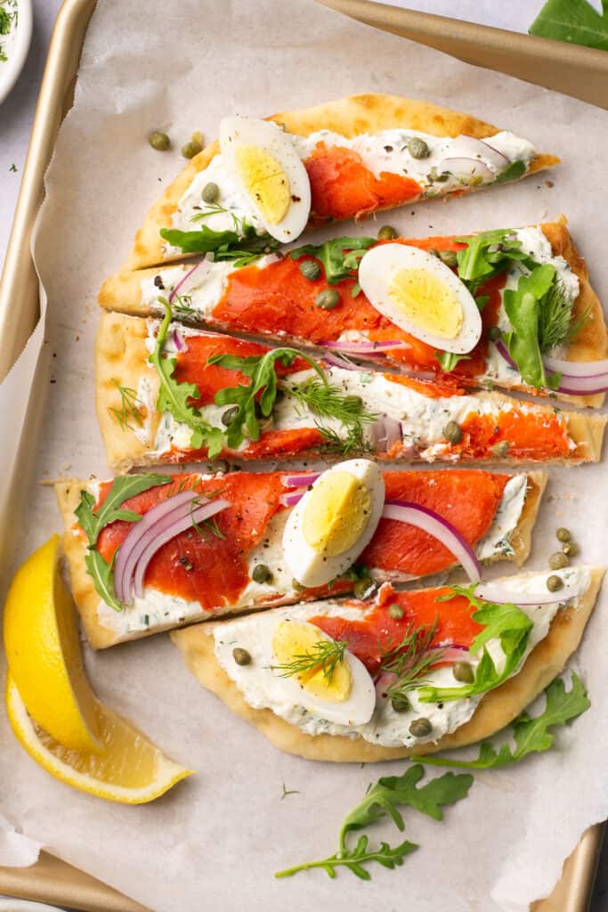 Smoked salmon flatbread topped with red onion, hard boiled eggs, and arugula. 