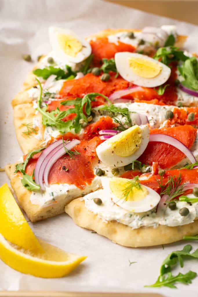 Smoked salmon flatbread topped with red onion, hard boiled eggs, and arugula. 